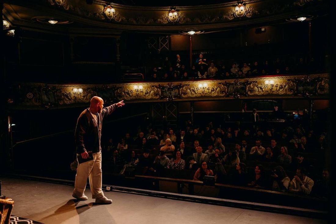 From the back of the theatre.