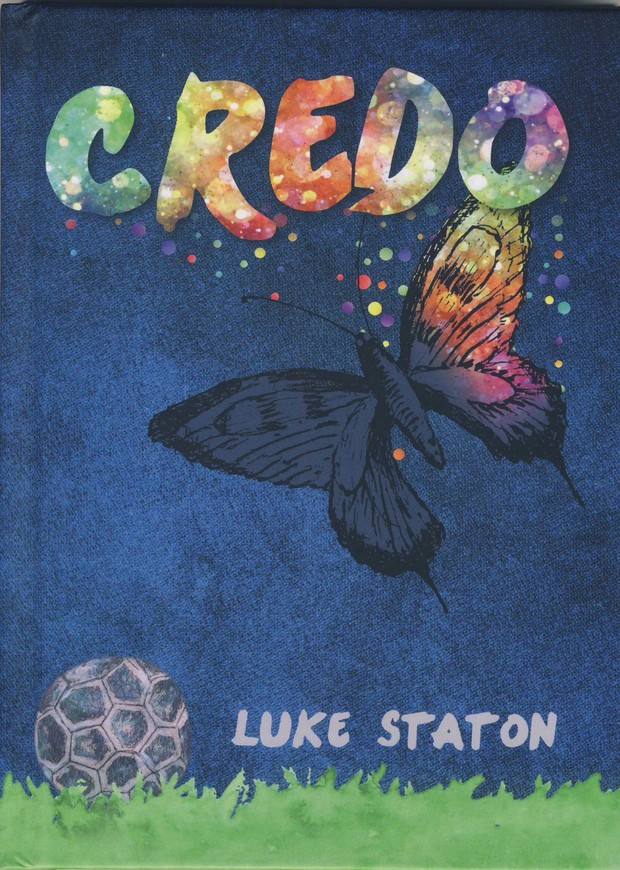 The cover of Credo by Luke Staton: a butterfly, half monochrome and half colour, above a football on grass.