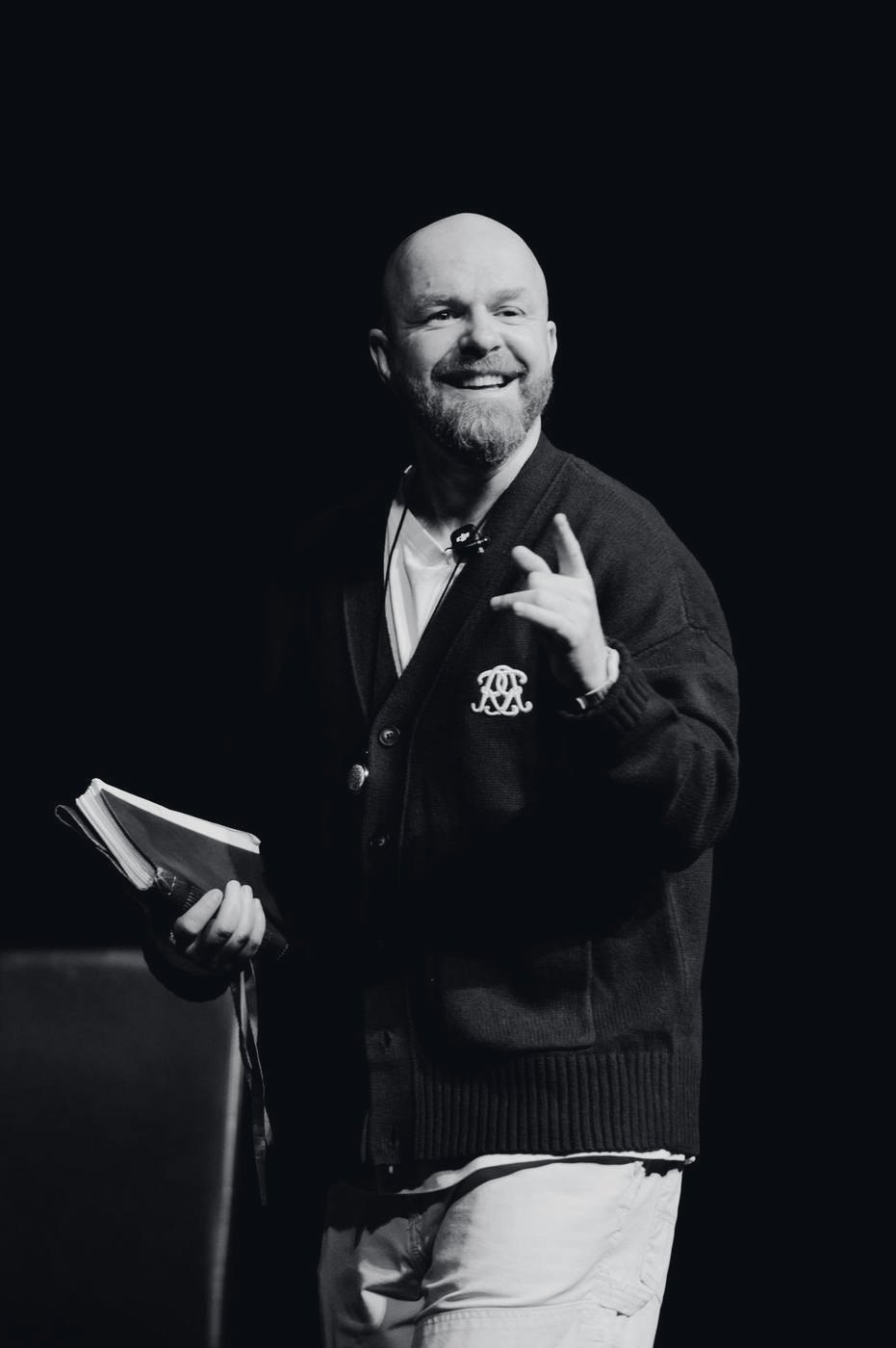 Luke Staton on stage, smiling, holding Credo.