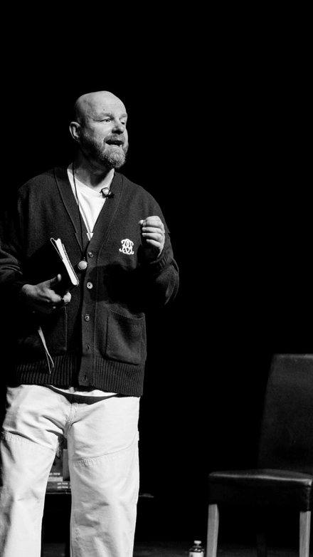 Luke Staton speaking on stage.